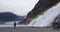 Tourist hiking woman hiker in Alaska walking by glacier and waterfall