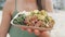 Tourist Holding Poke Salad Plate At Beach