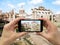 Tourist holds up camera mobile at forum in Rome