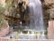 A tourist at the hot spring waterfall and natural pool at Hammamat Ma`In Hot Springs, Jordan