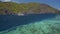 Tourist island hopping boat in ocean strait with rippled surface. Matinloc island. Tour C. Bacuit Archipelago