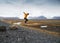 Tourist jumps over rocks in Iceland