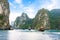 Tourist junks floating between limestone karsts and isles in Ha long Bay, Vietnam