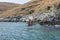 Tourist kayaking at Himara rocky shore