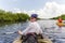 Tourist kayaking in mangrove forest in Everglades Florida, USA