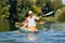 Tourist kayaking in the river from backward view