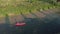 Tourist is kayaking at sunset. Young sportive woman floats in canoe on river. Water sports. Female is paddling in kayak in summer.