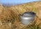 Tourist kettle in dry grass