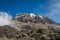 Tourist and Kibo peak in Mount Kilimanjaro, Tanzania