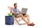 Tourist with a laptop sitting in a deck chair next to a cooling