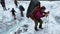 A tourist with a large backpack walks along the glacier.