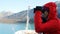 Tourist looking at Alaska Glacier Bay landscape using binoculars on cruise ship