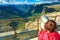 Tourist looking through binoculars in mountains, Norway