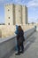 Tourist looking Calahorra tower by urban telescope