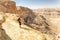 Tourist looking at desert canyon mountains landscape view.