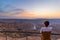 Tourist looking at the Fish River Canyon, scenic travel destination in Southern Namibia. Ultra wide angle view from above, colorfu