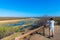 Tourist looking at panorama with binocular from viewpoint over the Olifants river, scenic and colorful landscape with wildlife in