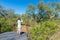 Tourist looking at panorama with binocular from viewpoint over the Olifants river, scenic and colorful landscape with wildlife in