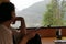 A tourist looks at the landscape as rain falls while on a motorhome holiday