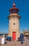 A tourist looks at the Lighthouse on Ramsgate Royal Harbour West Pier. The tower was built in 1842