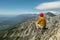 Tourist looks at the mountain landscape after climbing the peak. Motivation and achievement of their goals