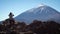 Tourist looks at the Teide volcano with binoculars