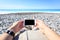 Tourist Lying On The Beach With Phone