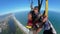 A tourist make skydiving with the Instructor over Barra da Tijuca beach.