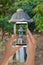 Tourist makes a photo of japanese garden lantern