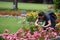 A tourist making a photo in a rosarium