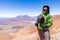 Tourist man adventurer backpacker standing mountain peak, Bolivi