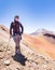 Tourist man adventurer backpacker standing mountain peak, Bolivia