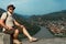 A tourist man with backpack on the background of a stunning bird`s-eye view of the Mtkvari river meeting the Aragvi river.