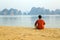 Tourist man at beach, limestone view of halong bay, vietnam