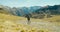 Tourist man climbing mountain with hike backpack on vacation travel on sunny day