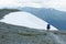 Tourist man coming down from of the Pass Kara-Turek, Altai Mountain