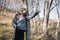 Tourist man holding poles and pointing for direction in mountain