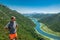 Tourist man on Pavlova Strana View Point. Beautiful summer landscape of green mountains, blue sky and Crnojevica river. Montenegro