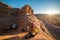 Tourist man prepearing campground with a ten in mountain desert at sunset time. Travel lifestyle photo