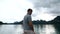 Tourist Man Standing on the Boat and Enjoying Beautiful View on Morning Lake