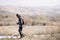 Tourist man walking on field with mountain view