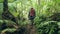 Tourist man walking on pathway hiking in tropical rainforest back view. Traveling man with backpack going in wild jungle