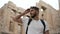 Tourist men take glasses off to look around Acropolis ruins in Greek Athens.