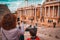 Tourist mother and child taking a picture in the antique Roman Theatre of Merida, Spain.