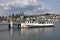 Tourist motor vessel moored in the harbor of city of Lucerne situated on Lake Lucerne during sunny day with heap cloud,