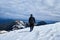 Tourist mountaineer climbs over the snowy mountains to the summit