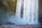 Tourist near Skogafoss waterfall in Iceland