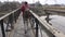 Tourist and Nepalese man on sacred Bagmati river bridge