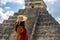 Tourist observing the old pyramid and temple of the castle of the Mayan architecture known as Chichen Itza