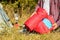 Tourist packing red sleeping bag outdoors, closeup